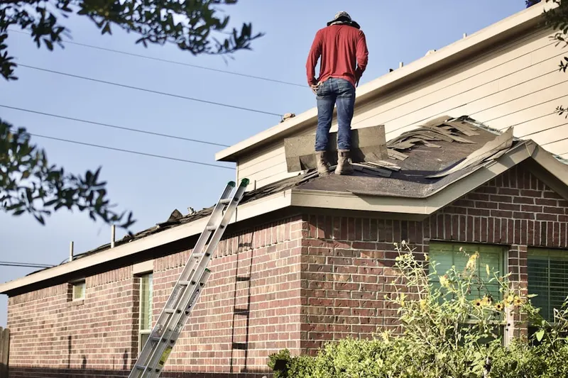 Professional roofer working on a residential roof in St. Augustine Beach